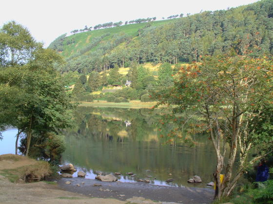 Looking towards a lake with a tree-covered hill beyond